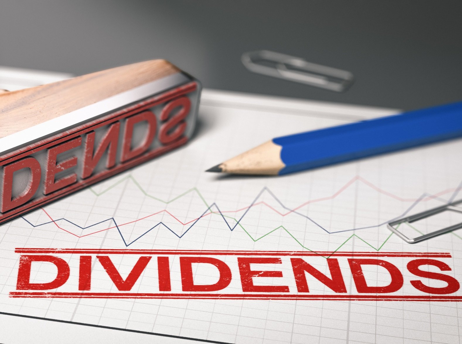 Rubber stamp with the word dividend printed over a stock chart.  Concept of investment. 3d illustration.